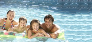 family enjoying a heated pool