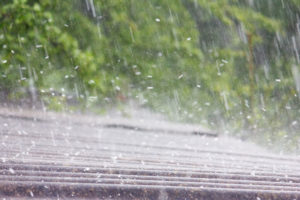 summer rain with hail falls on the roof of slate