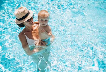 mother-with-little-son-having-fun-pool mother-with-little-son-having-fun-pool